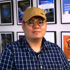 A man wearing a baseball hat and glasses.