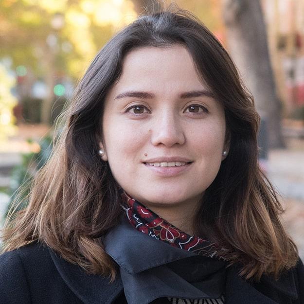 A woman smiles at the camera.