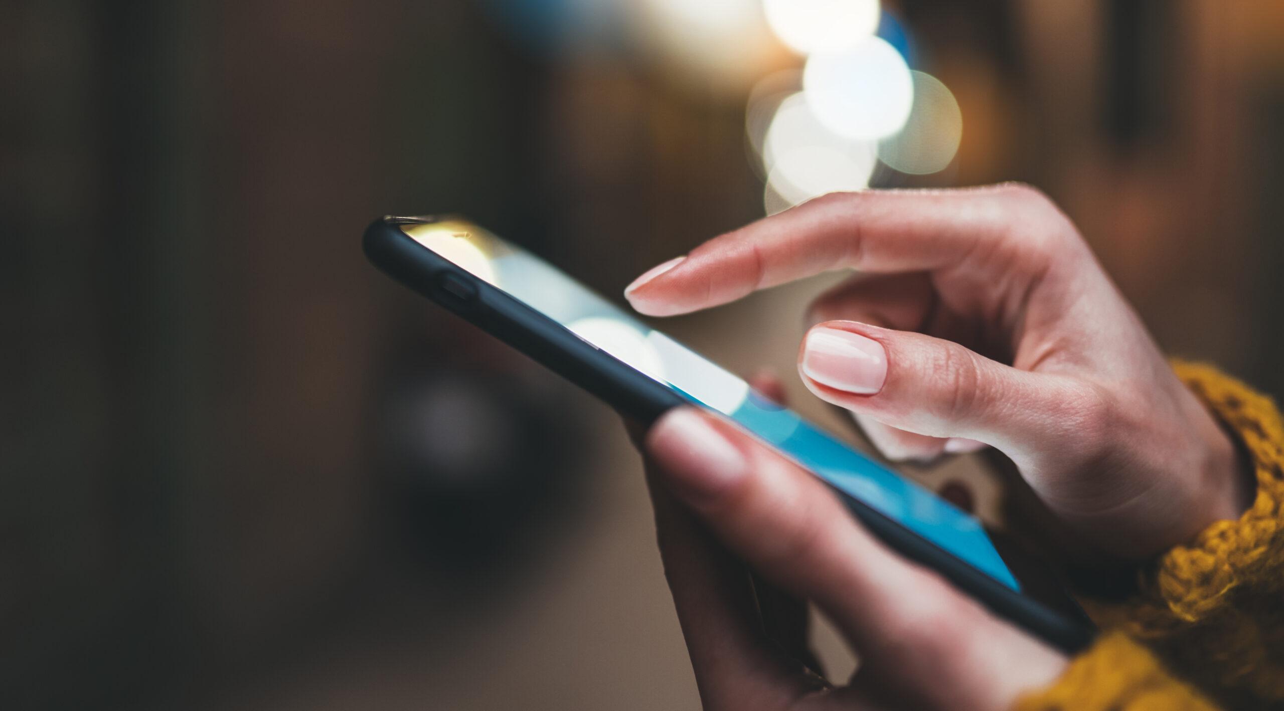 A person's hand using a smartphone