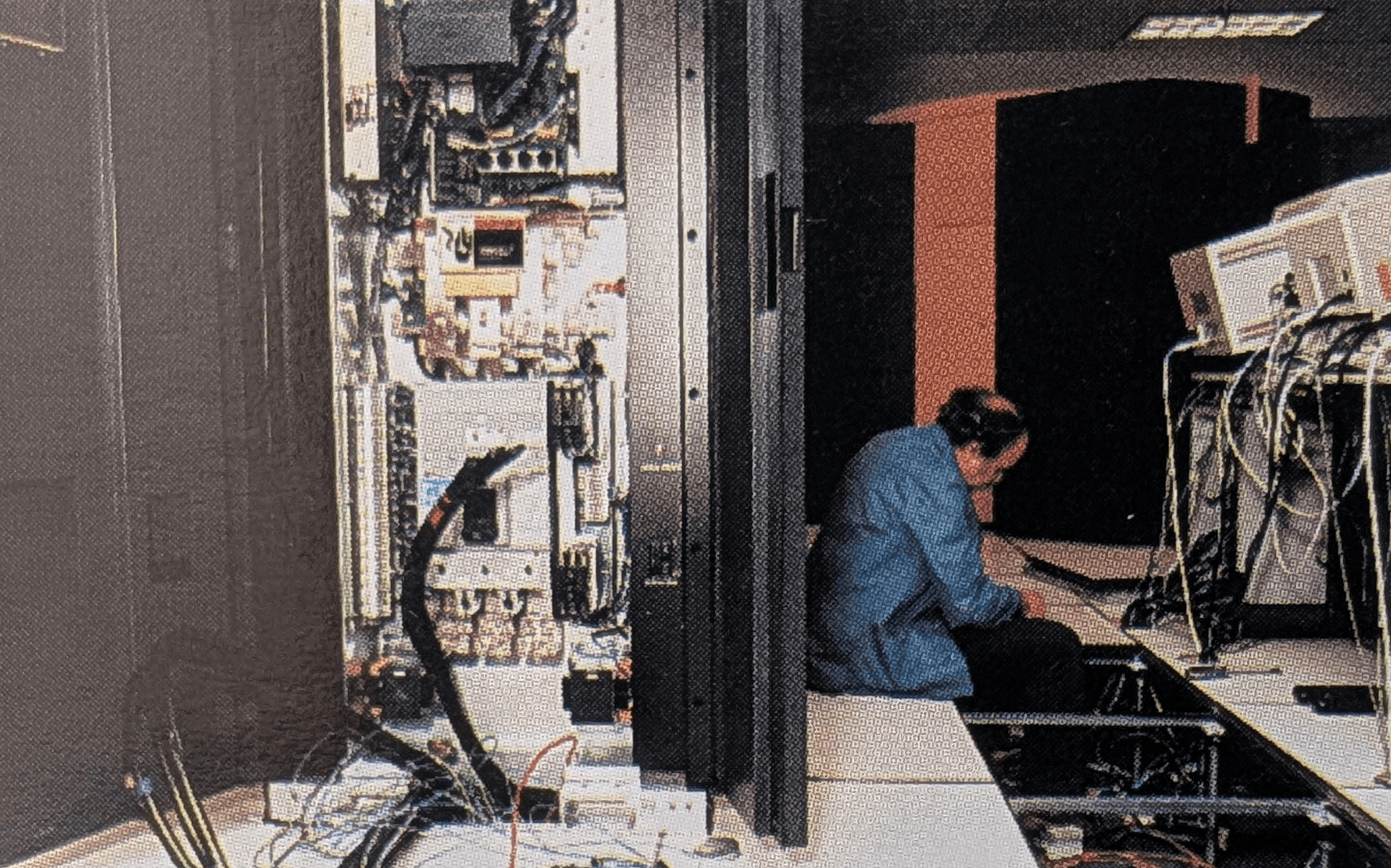 1990's era photo of a person installing a new machine at PSC